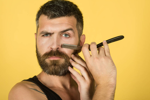 Serious hipster in barbershop, new technology - Valokuva, kuva