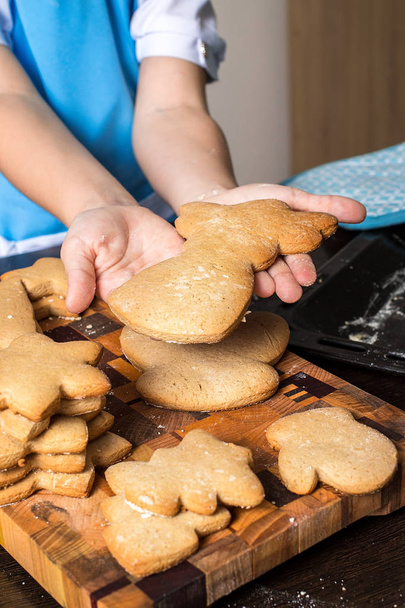 Christmas Gingerbread cookies and kids hands.  - Fotó, kép