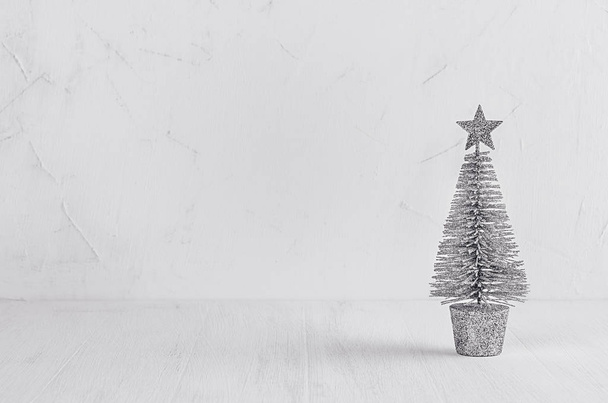 Silver christmas tree on white shabby plaster and wood board.  - Photo, Image