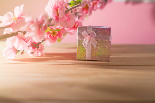 Gift box wrapped and plum blossom Christmas and Newyear presents with bows and ribbons, Christmas frame boxing day background and banner. - Photo, Image