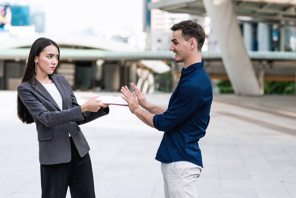 Sale woman trying to sell insurance to potential male client. Beautiful young sale woman trying hard to sell insurance to handsome young rich white male. Taken outdoor. Confident sale woman concept. - Foto, imagen