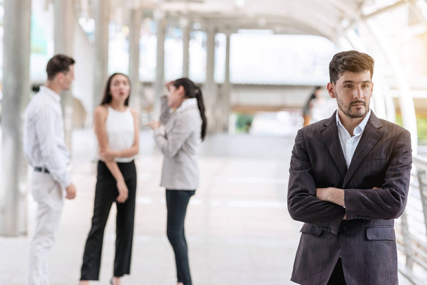 Confident young business team portrait concept. Handsome white male in smart casual dress portrait outdoor with his team in background, successful modern start up concept. - Valokuva, kuva