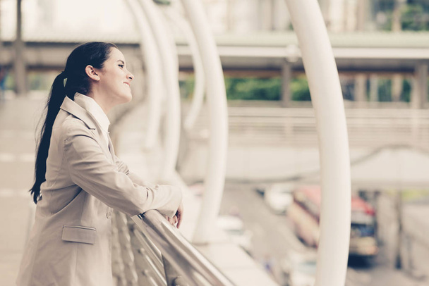 Portrait of confident businesswoman. Young professional career business woman standing  outside looking confident. Apply vintage effect. For young woman leadership, career path concept. - 写真・画像