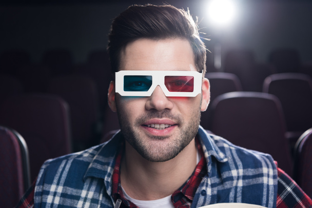 handsome man in 3d glasses watching film in cinema - Photo, Image