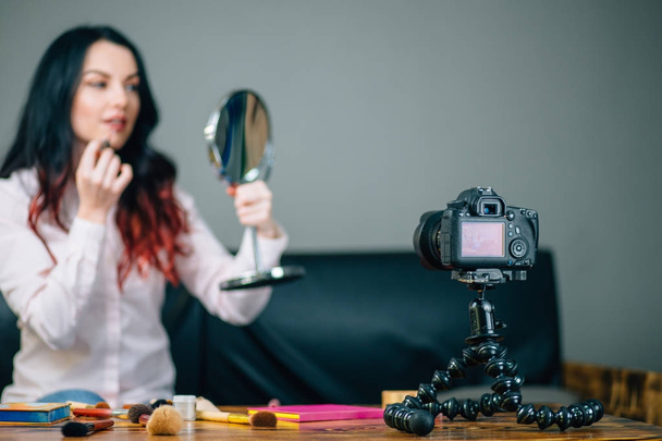 blurred blogger with makeup cosmetics recording video at home - Φωτογραφία, εικόνα