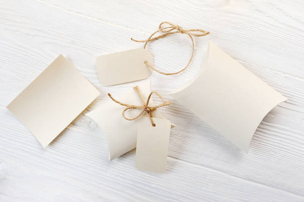 Mockup letter, boxes of bonbonniere and tag with place for your text on a white wooden background - Фото, зображення
