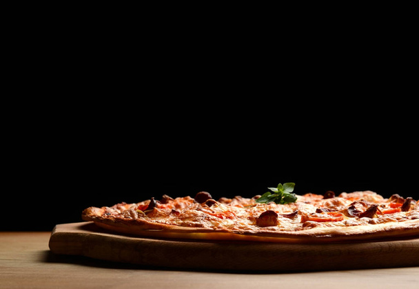 Hot big pepperoni pizza tasty pizza composition with melting cheese bacon tomatoes ham paprika - Foto, afbeelding