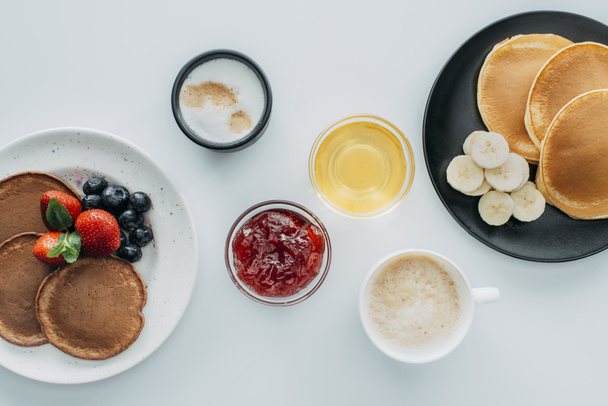 top view of breakfast for two with pancakes and coffee on white table - Photo, Image