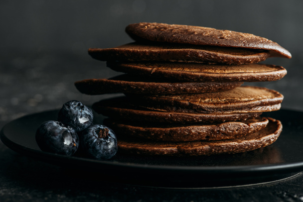 close-up shot of stack of chocolate pancakes with blueberries - Zdjęcie, obraz