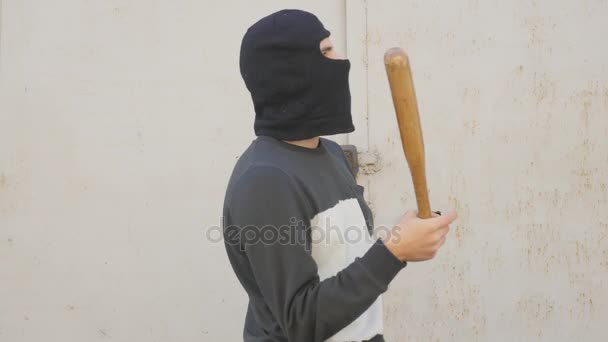 Aggressive masked man with a baseball bat - Imágenes, Vídeo