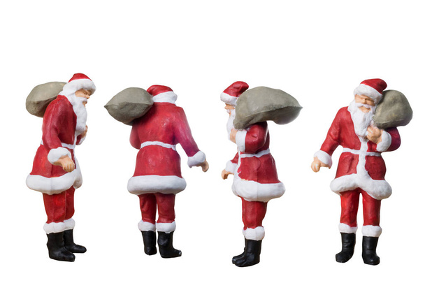 Миниатюрные люди Санта-Клаус с сумкой изолированы на белом
  - Фото, изображение