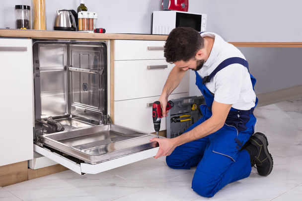 Technician Repairing Dishwasher - Photo, Image