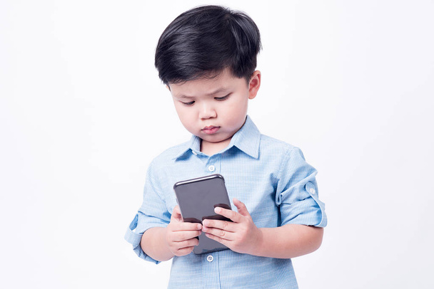 boy playing mobile phone on white background - Fotó, kép