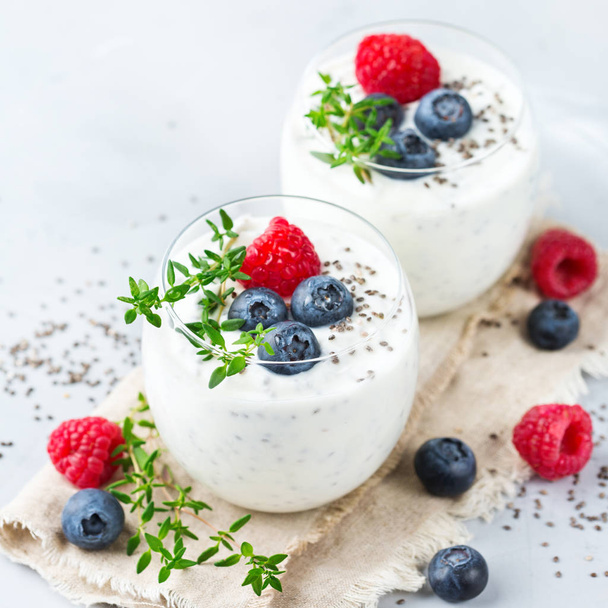 Healthy vegan white chia pudding with berries and green thyme - Φωτογραφία, εικόνα