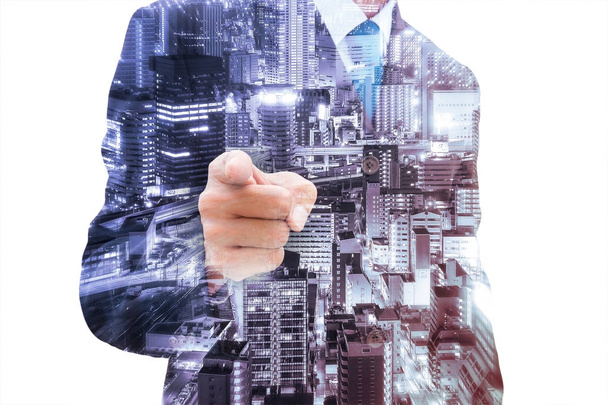 Double exposure of businessman pointing out and abstract zoom of city at night. - Photo, Image