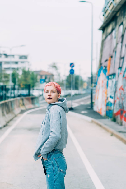 young woman pink hair outdoors posing looking camera - blogger, influencer concept - Foto, Bild