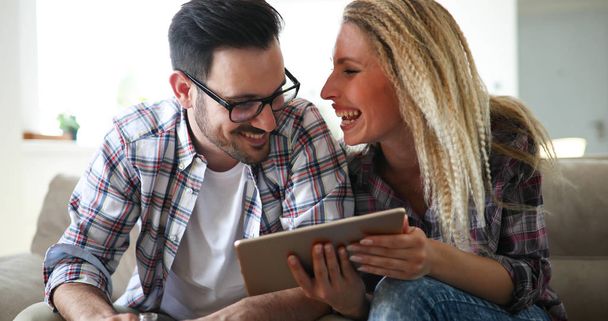 Happy couple in love surfing on tablet  - 写真・画像