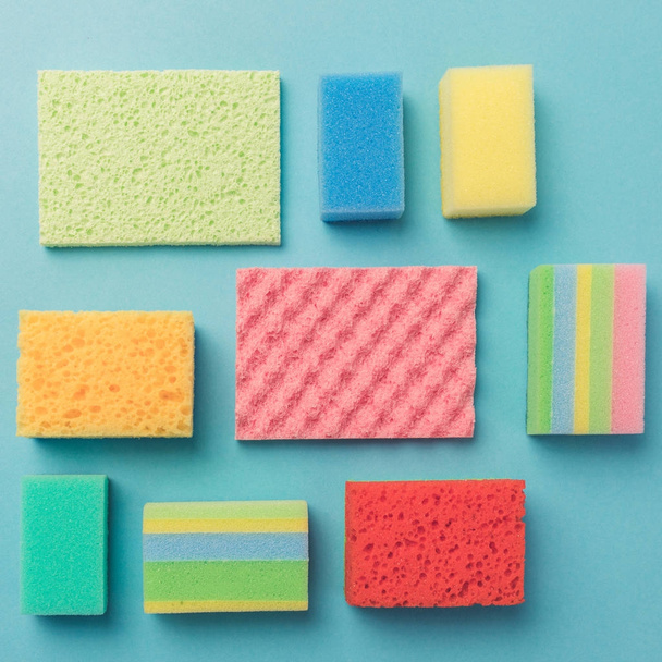 top view of background with colorful washing sponges, on blue - Photo, Image