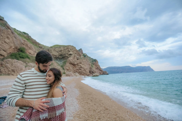 half length of handsome man hugging his pretty woman standing on sea beach - Foto, immagini