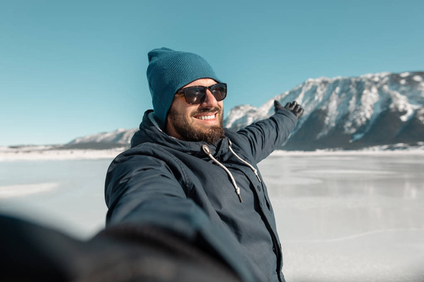 man making selfie on frozen lake - Фото, зображення