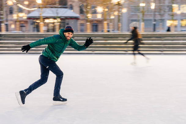 Happy active sporty male involved in winter activities, demonstr - Fotó, kép