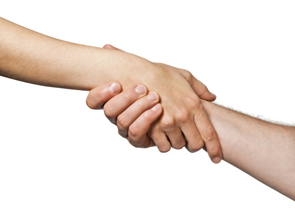 Two hands  united  in a handshake. Concept of  salvation, help, guardianship, protection, love, care etc. Image on white, isolated  background. - Photo, Image