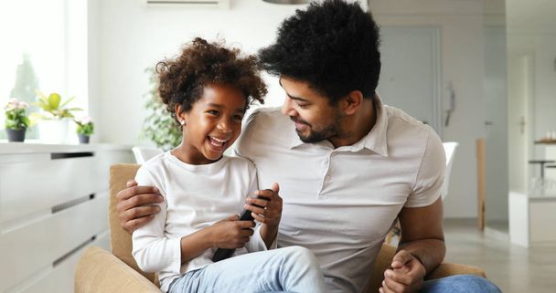 african american family watching tv - Фото, изображение