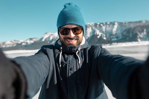 man making selfie on frozen lake - Фото, зображення