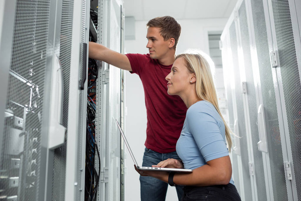 Team of technicians working together on servers at the data centre - Fotografie, Obrázek