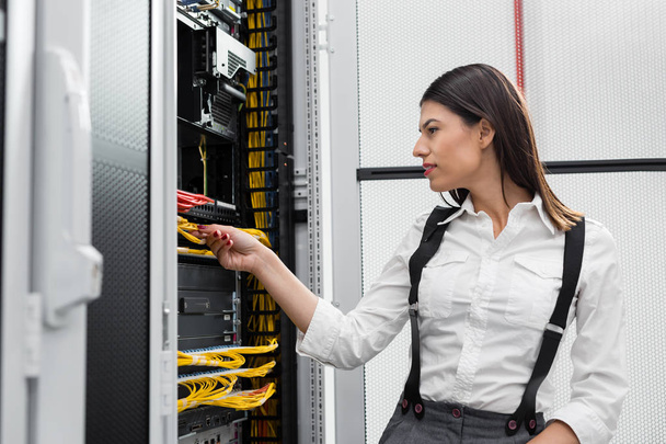 Young engineer businesswoman in network server room - 写真・画像