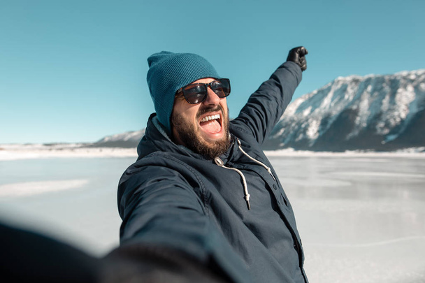 man making selfie on frozen lake - Photo, Image