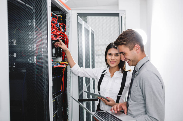 Team of technicians working together on servers at the data centre - Фото, зображення