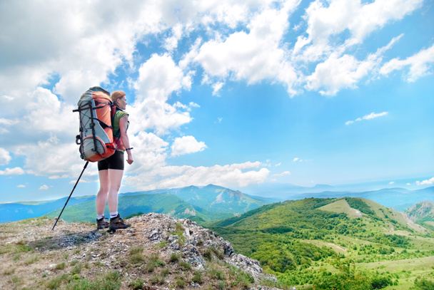 Happy hiking woman with backpack on top of green mountain  - Photo, Image