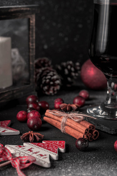 Mulled wine, hot drink with spices on a black background, wine, alcohol, winter, snow - Photo, Image