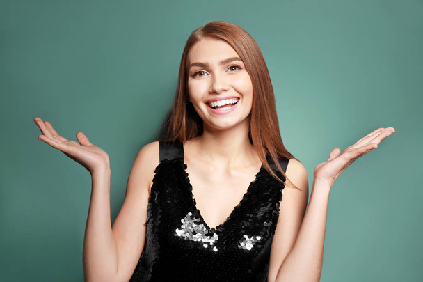 Portrait of young happy smiling woman on color background - Photo, image