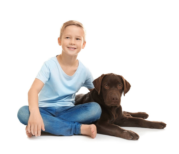 Cute little boy with dog on white background - Foto, Imagen