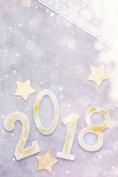 Luxury glitter numbers 2018 with keyboard and gold stars under snow on grey background. New year concept. Text space - Foto, Bild