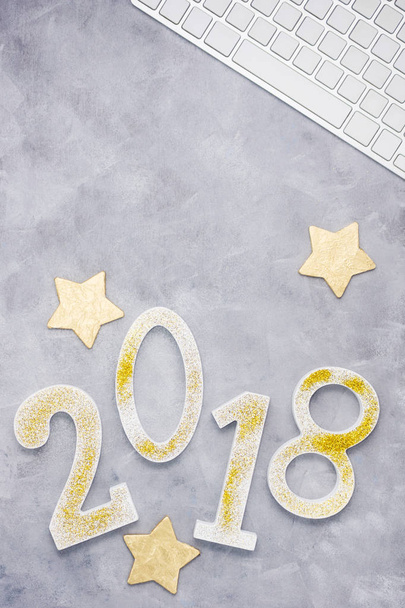 Luxury glitter numbers 2018 with keyboard and gold stars on grey background. New year concept. Text space - Photo, image