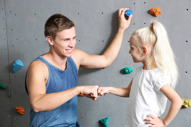 Little girl and instructor in climbing gym - Photo, image