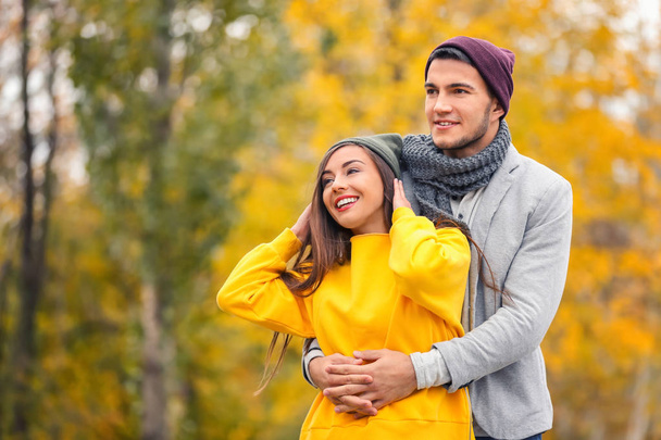 Young couple in park on autumn day - Фото, изображение