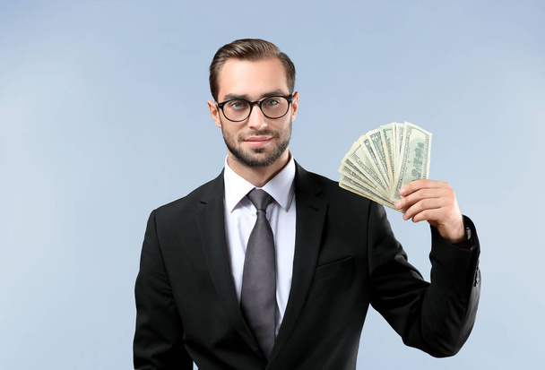 Handsome businessman with dollar bills  - Фото, зображення
