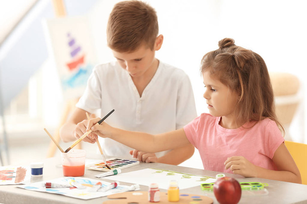 Little children painting at table - Fotó, kép