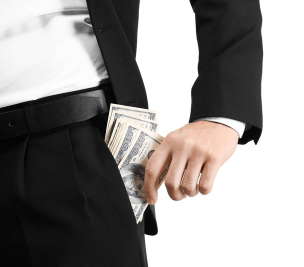 Businessman with dollar bills in pocket on white background, closeup - Фото, изображение
