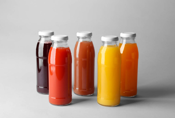 Bottles with juices on light background - Photo, Image
