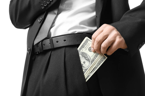 Businessman with dollar bills in pocket on white background, closeup - Fotó, kép