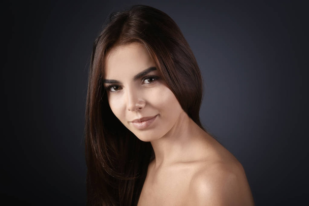 Beautiful young woman with eyelash extensions on grey background - Φωτογραφία, εικόνα