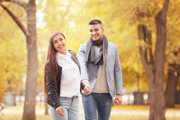 Young couple walking in park on autumn day - Foto, Imagem
