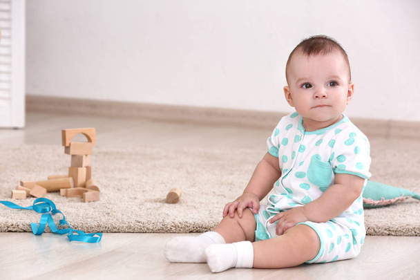 Cute baby sitting on floor at home - Photo, Image