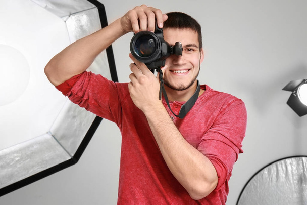 Young photographer working in professional studio - Fotoğraf, Görsel