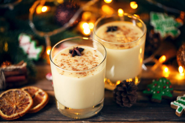 Eggnog in glasses with star anise on wooden table - Zdjęcie, obraz